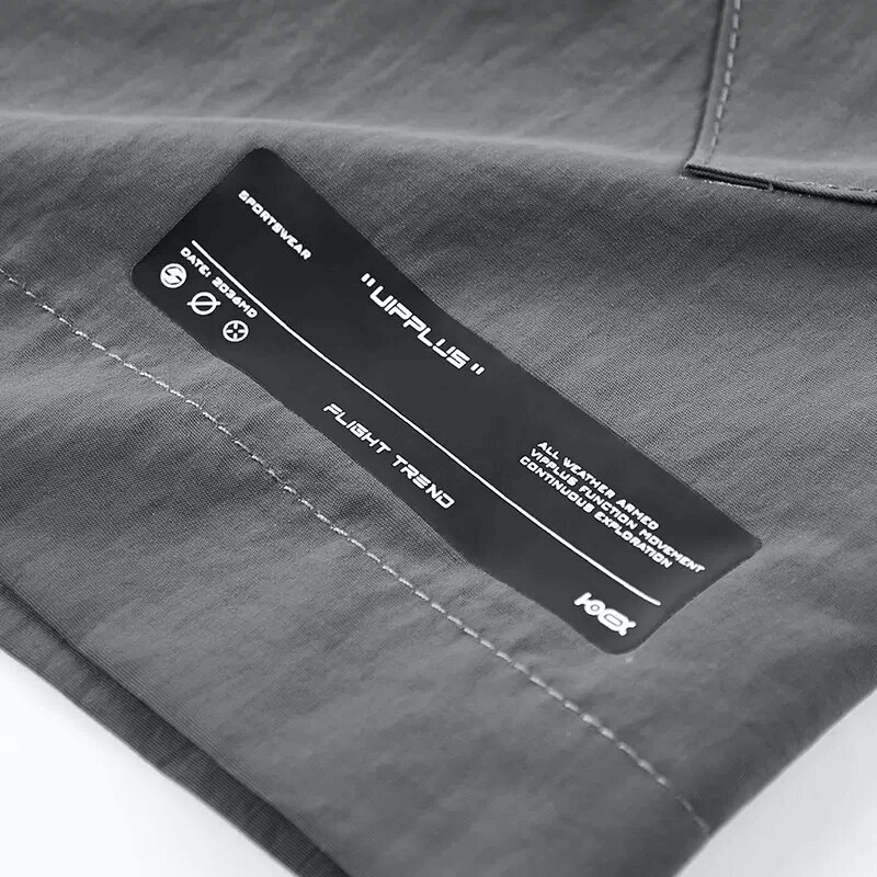 Close-up of the fabric label on men's tactical shorts, showcasing features and brand details.