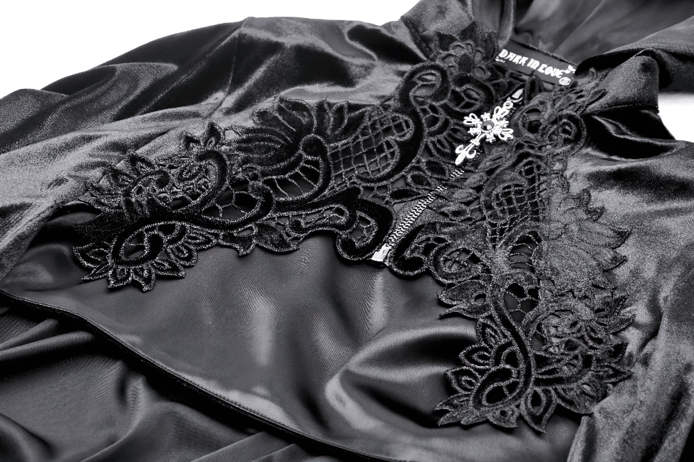Close-up of black velvet cape featuring intricate embroidery, perfect for adding gothic flair to any outfit.