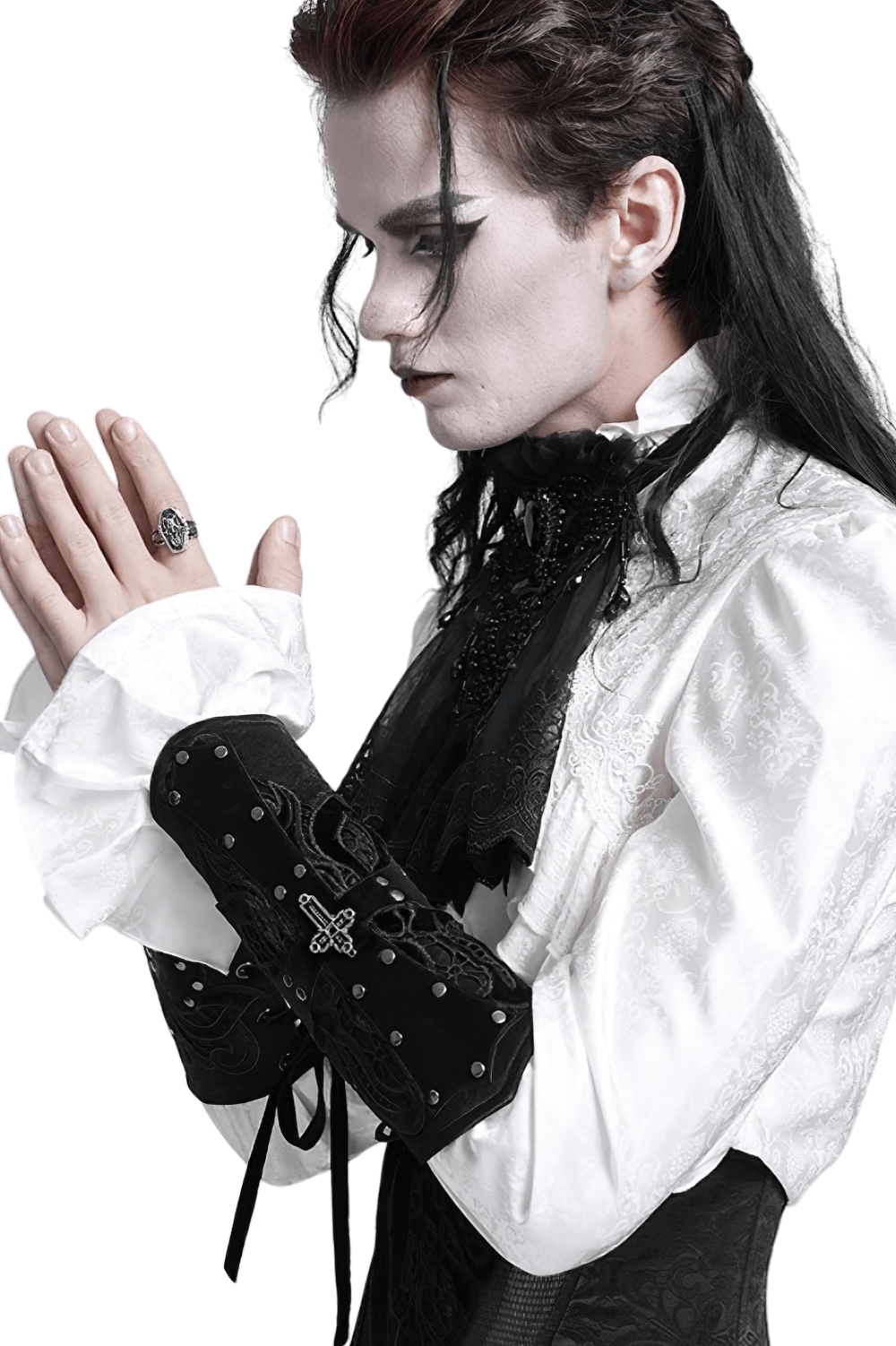 A gothic-inspired man in a white shirt with lace details and black cuffs, showcasing an elegant alternative fashion style.