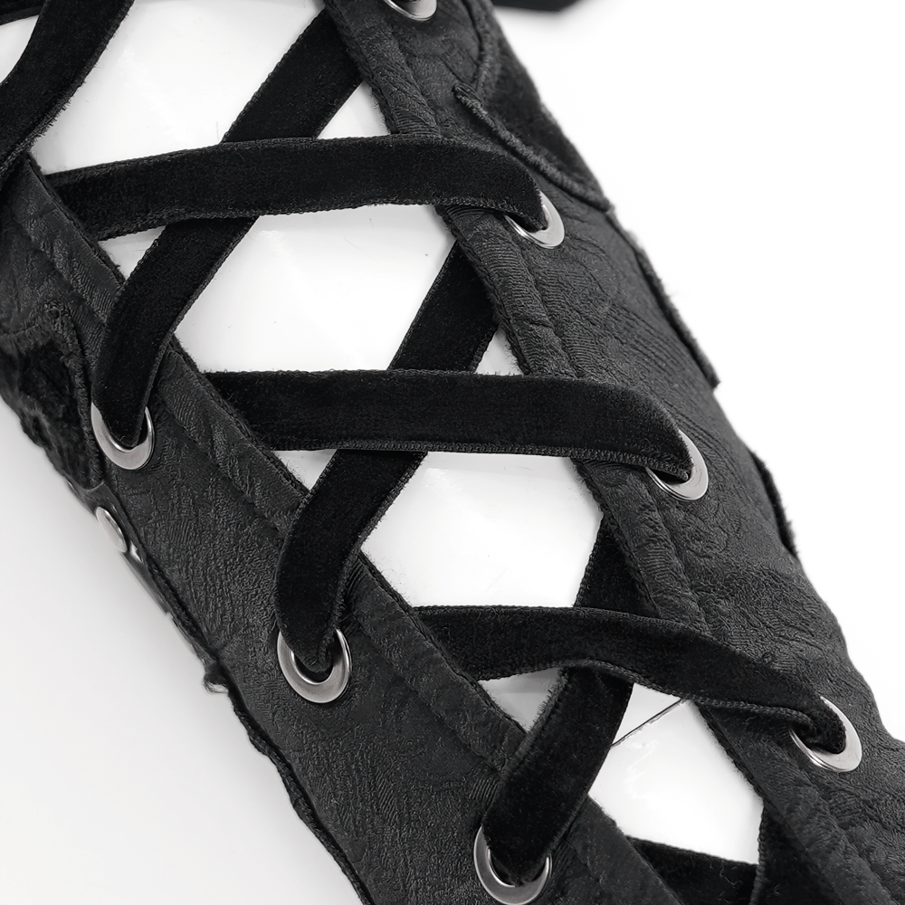 Close-up of an elegant black gothic bracelet with lace detailing and eyelets in synthetic leather.