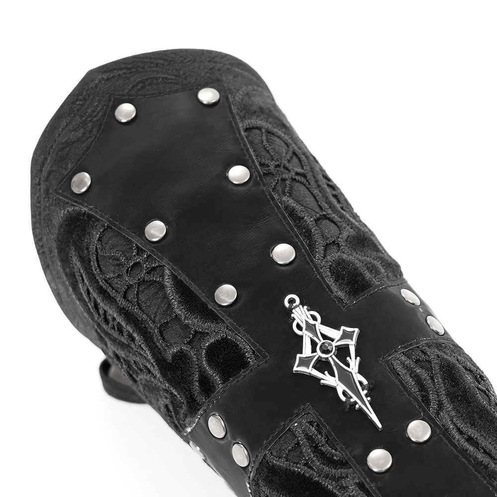 Close-up of an elegant gothic bracelet featuring lace details and a silver cross pendant on black synthetic leather.