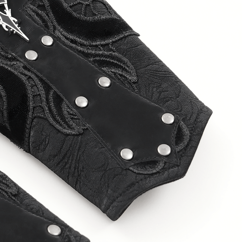 Close-up of an elegant gothic bracelet featuring lace details and bold synthetic leather with decorative metal studs.