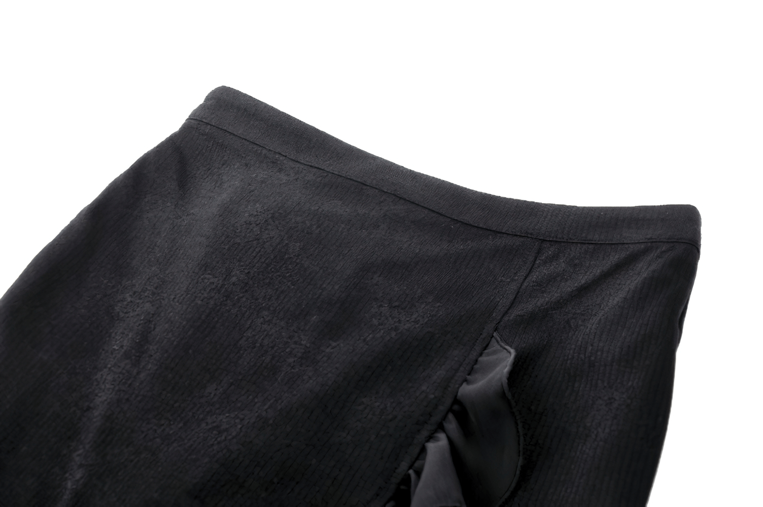 Elegant black high-waisted skirt featuring a subtle ruffle detail, showcasing a flowy and stylish design.