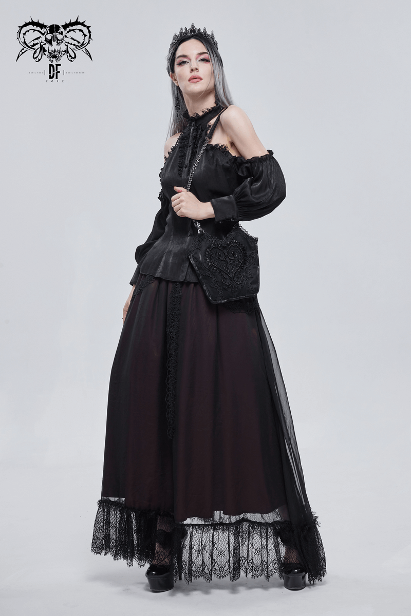 Elegant woman in gothic black outfit with flowing skirt and intricate guipure bag, showcasing gothic fashion style.
