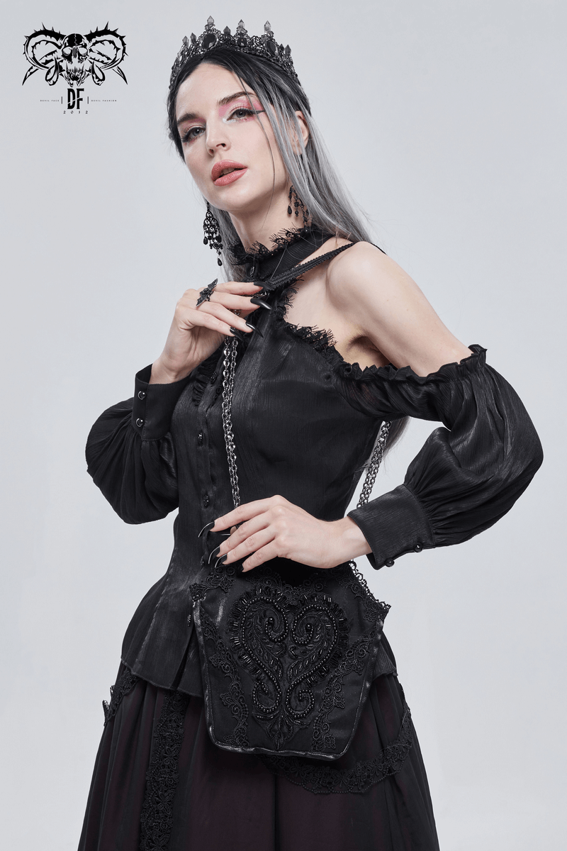 Elegant gothic woman in black outfit showcasing a black guipure and chain bucket bag.