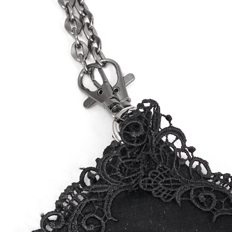 Close-up of the black guipure lace and chain detail on an elegant gothic-style women's bag.