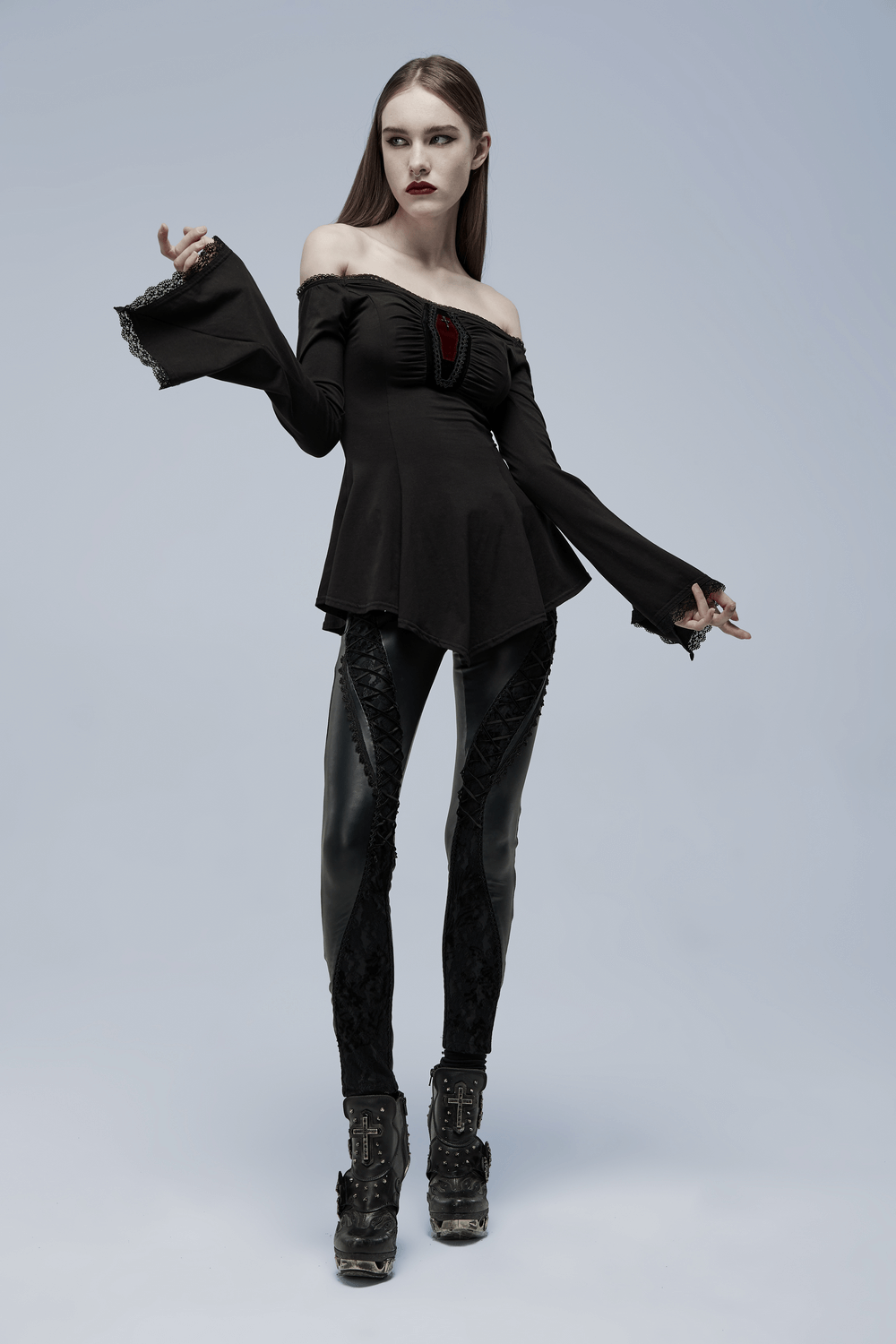 Elegant bell-sleeve goth top with coffin accent, paired with stylish black leggings, creating a striking fashion statement.