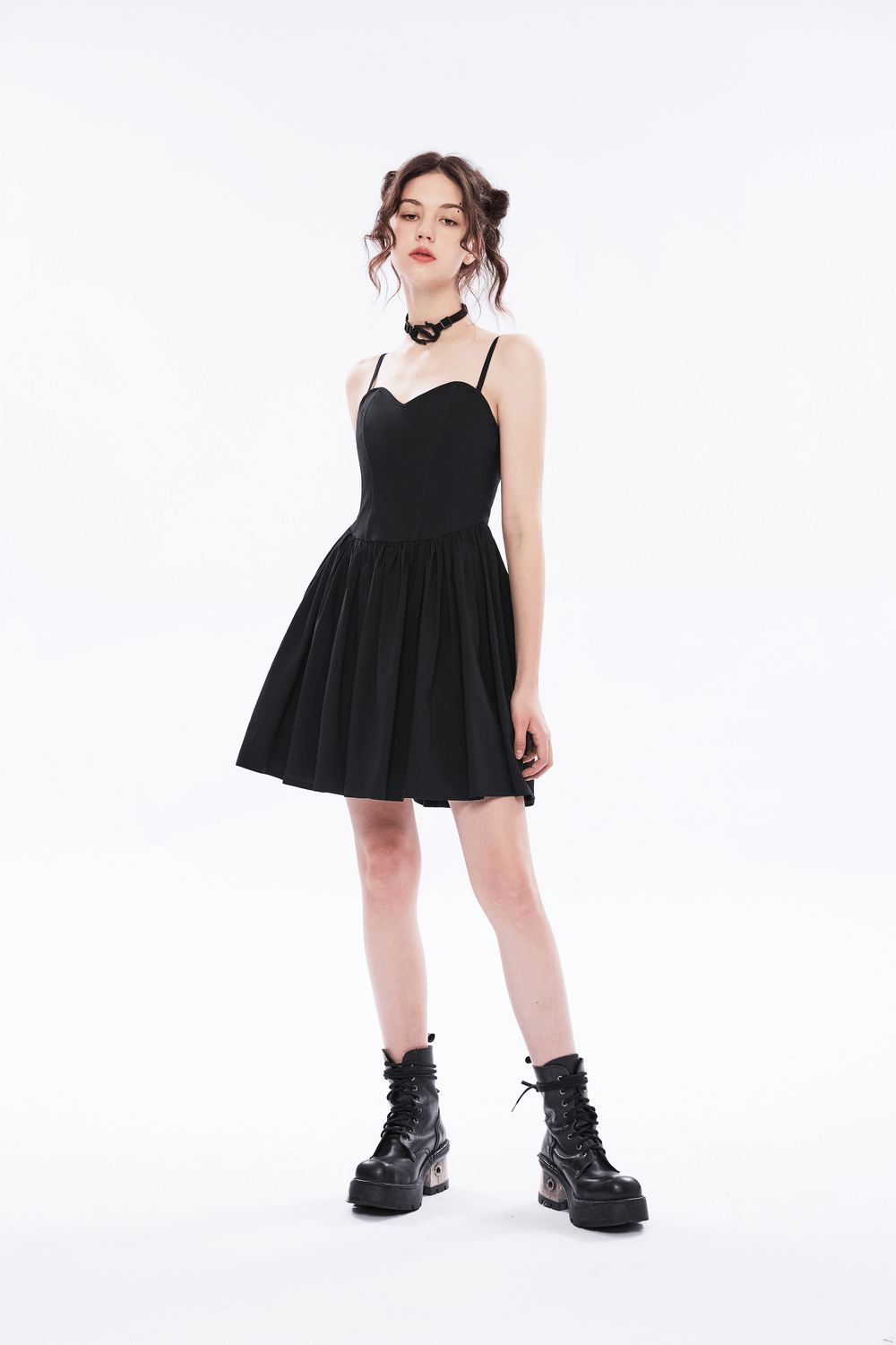 Elegant black A-line skater dress with pleated skirt and punk plaid interior, styled with edgy boots.