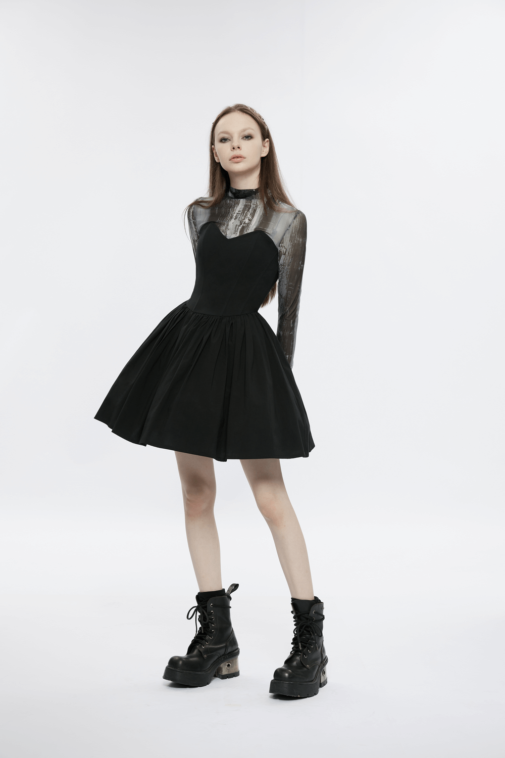 Elegant black A-line skater dress with transparent sleeves, paired with stylish combat boots.