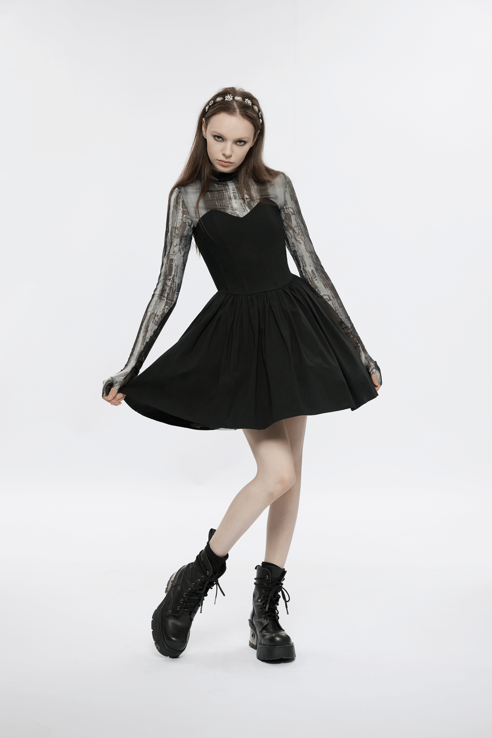 Elegant black A-Line skater dress with pleated skirt and unique plaid interior, styled with edgy black boots.