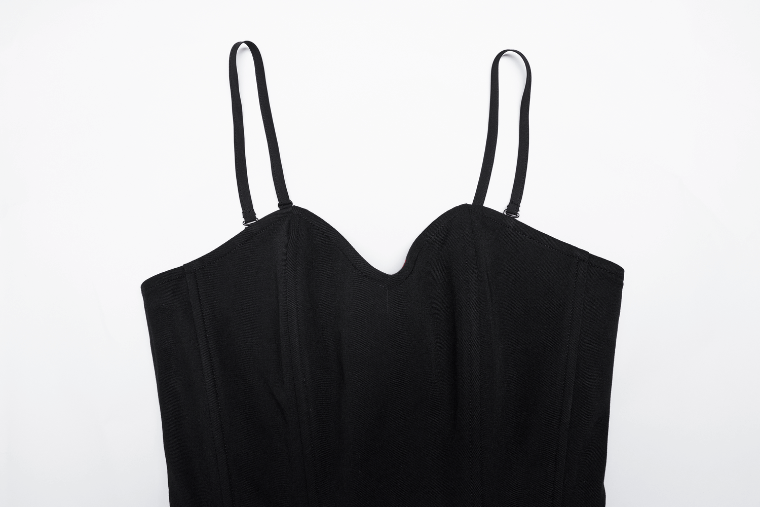 Close-up of elegant black A-line skater dress featuring adjustable straps and a unique circular chest design.