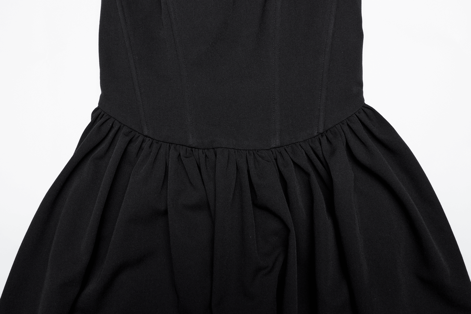Close-up of elegant black A-line skater dress showcasing pleated skirt and smooth bodice design.