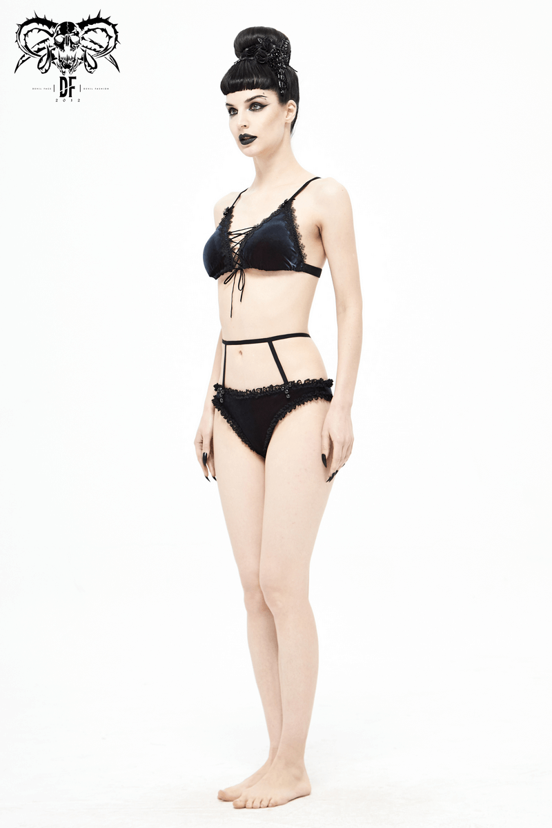 Elegant black and red bikini with lace, showcasing a gothic sexy style on a model in a studio setting.