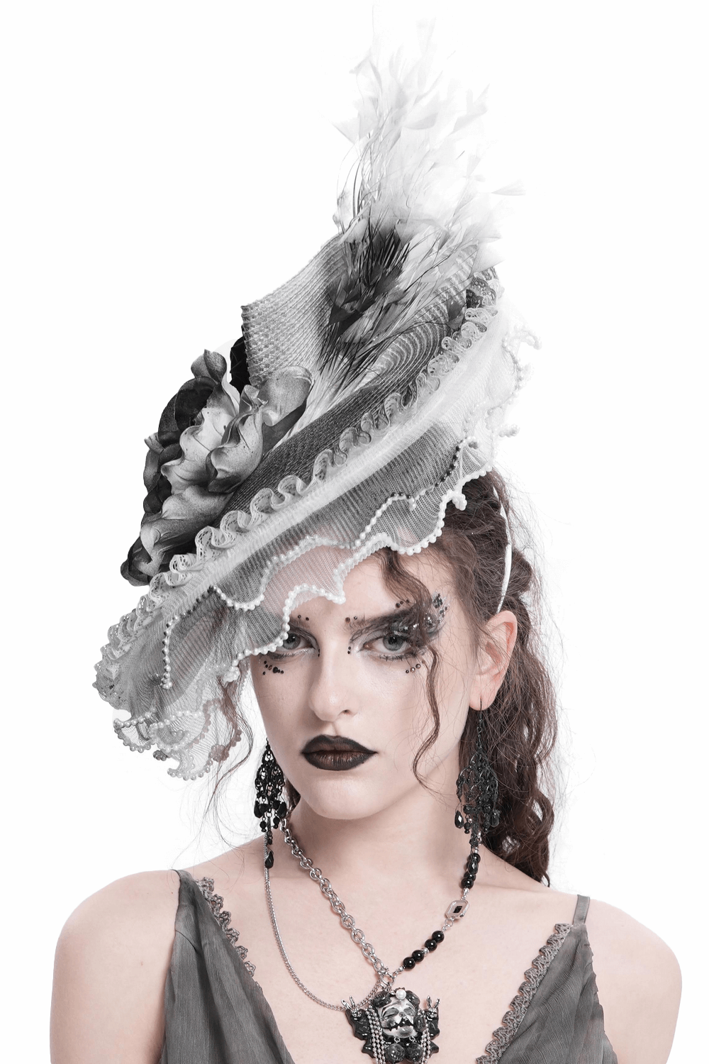 Elegant black and white floral fascinator hat adorned with feathers, perfect for gothic celebrations.