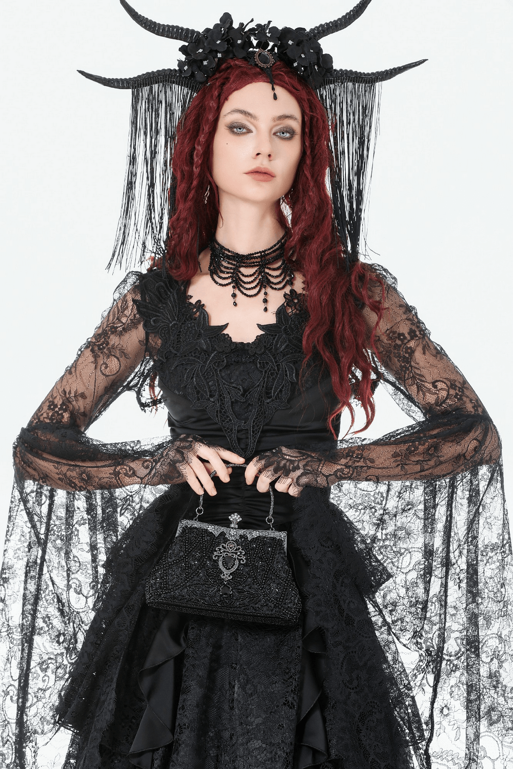 Elegant Black Beaded Evening Clutch with Silver Chain Strap against a dramatic black outfit and gothic accessories.
