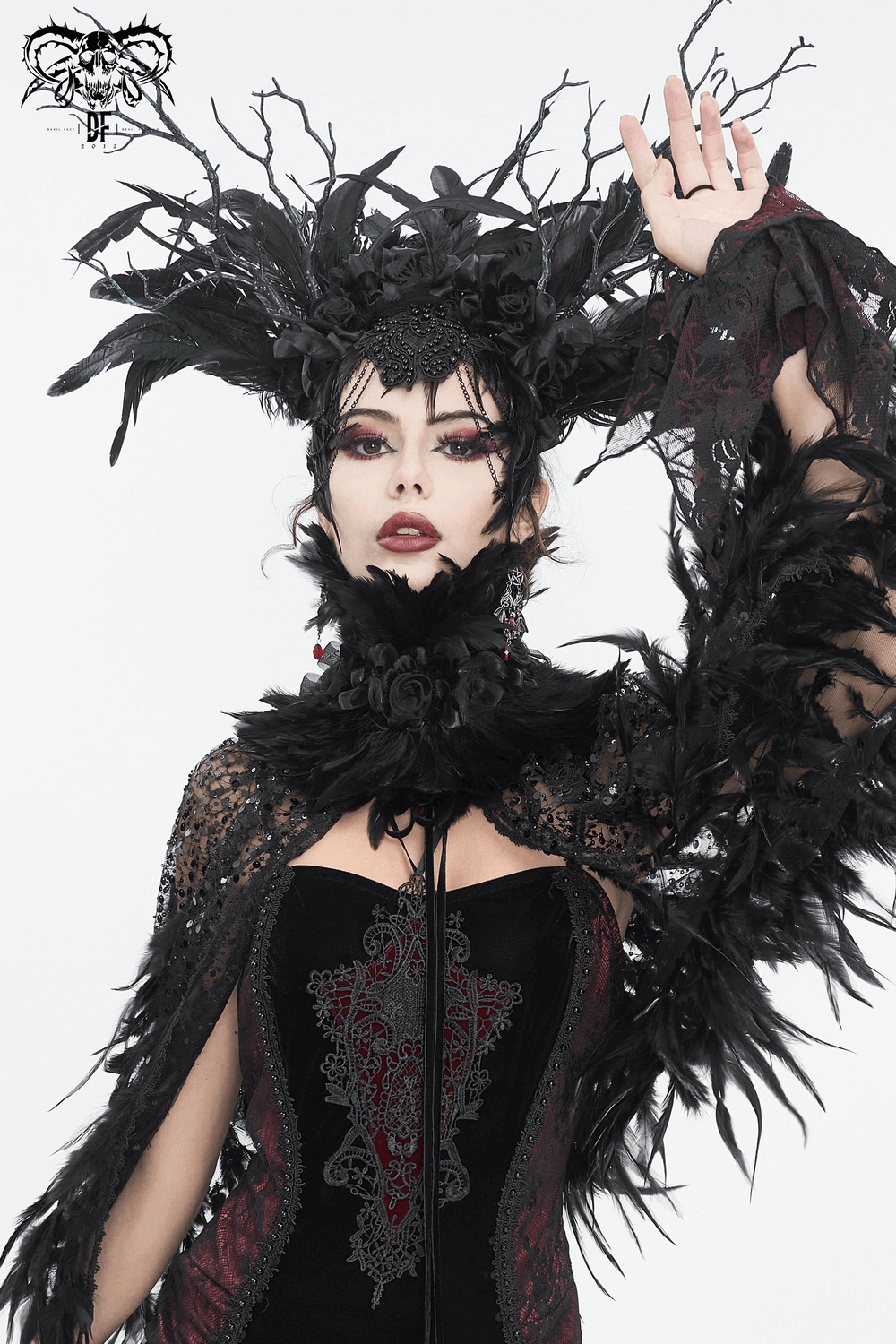 Gothic model showcasing a black collar with fabric flowers and feathers, exuding dark elegance and whimsy.
