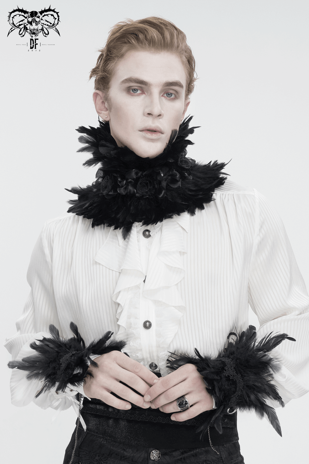 Gothic black collar with fabric flowers and feathers, worn by a model in a ruffled white shirt, showcasing a romantic style.