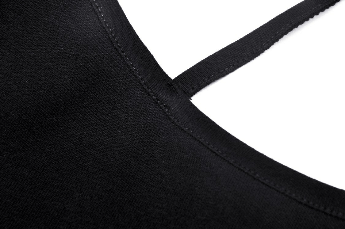 Elegant black crop top neckline with unique strap detail close-up, showcasing sophisticated design and styling.