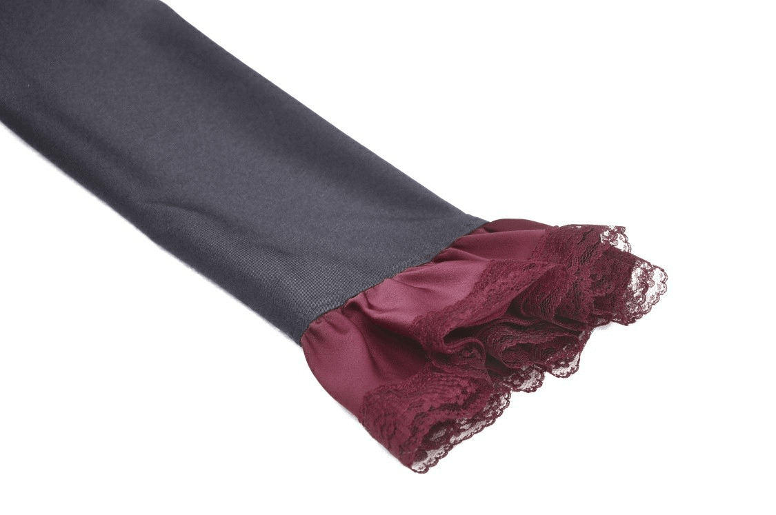 Close-up of elegant black dress sleeve featuring burgundy lace trim detail for a vintage-inspired look.