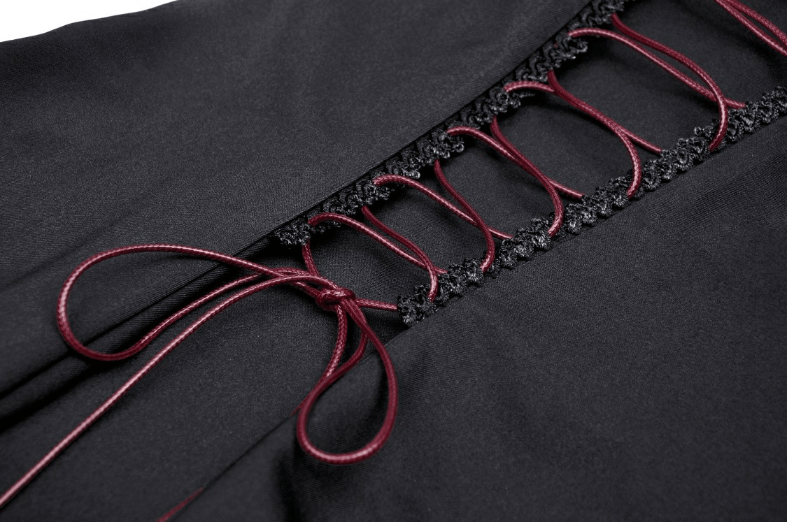 Close-up of the lace-up detail on an elegant black dress with burgundy accents.
