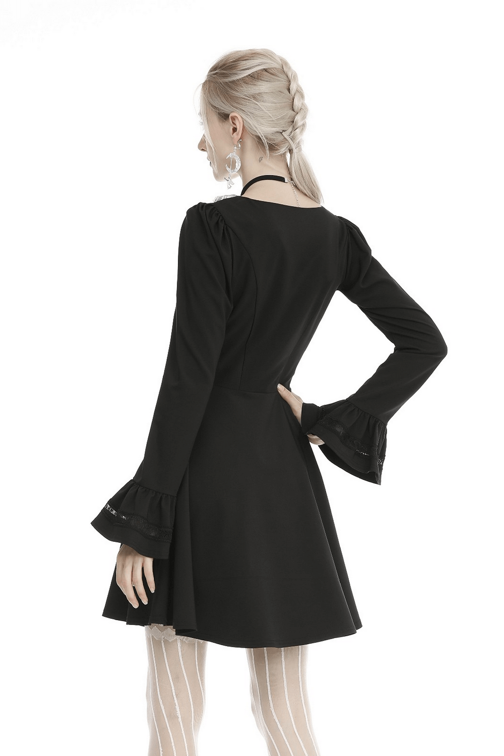 Back view of an elegant black dress featuring lace cuffs, showcasing vintage-inspired design and modern tailoring.