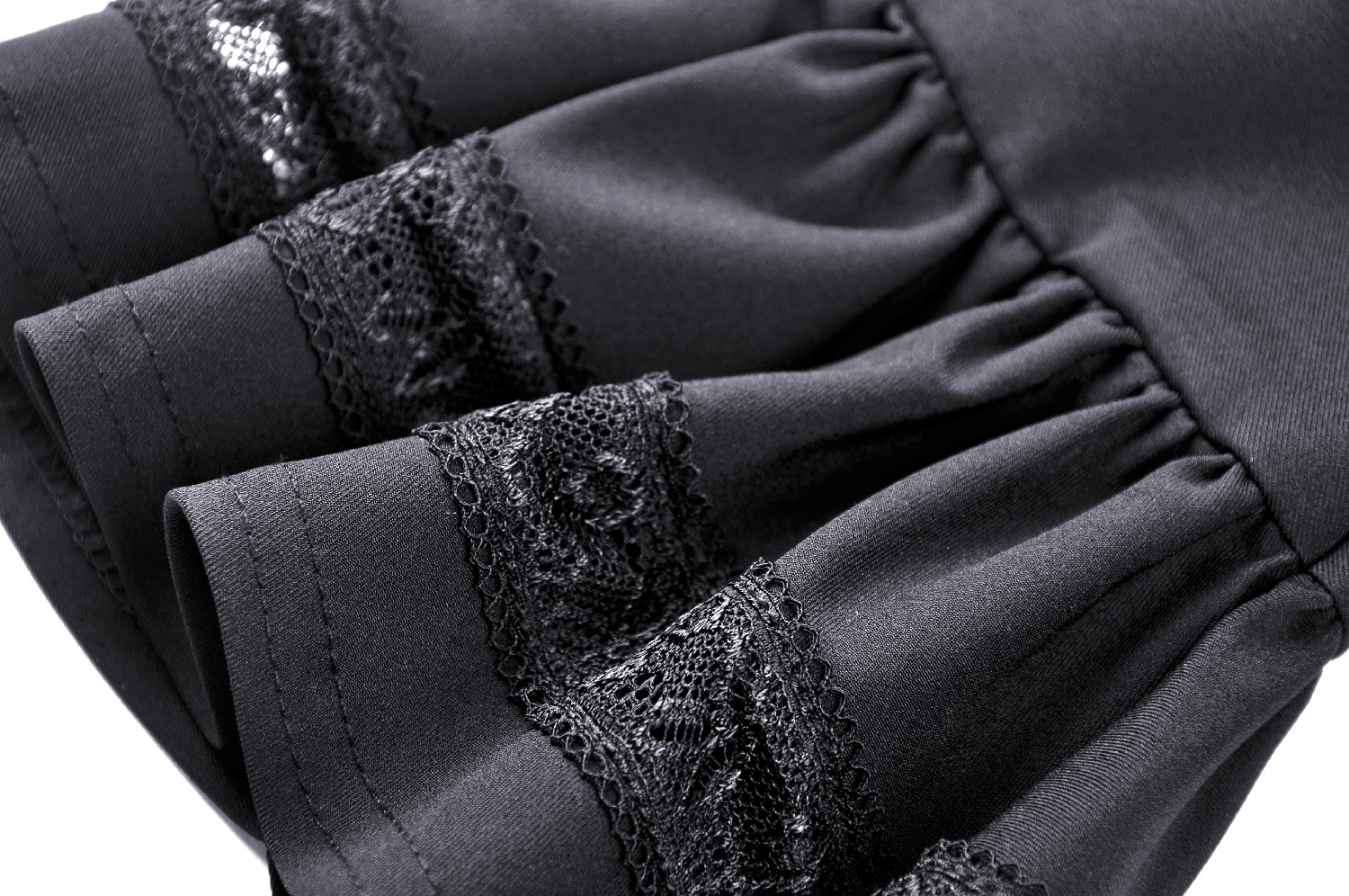 Close-up of elegant black dress sleeve with intricate black lace detailing for vintage-inspired fashion.