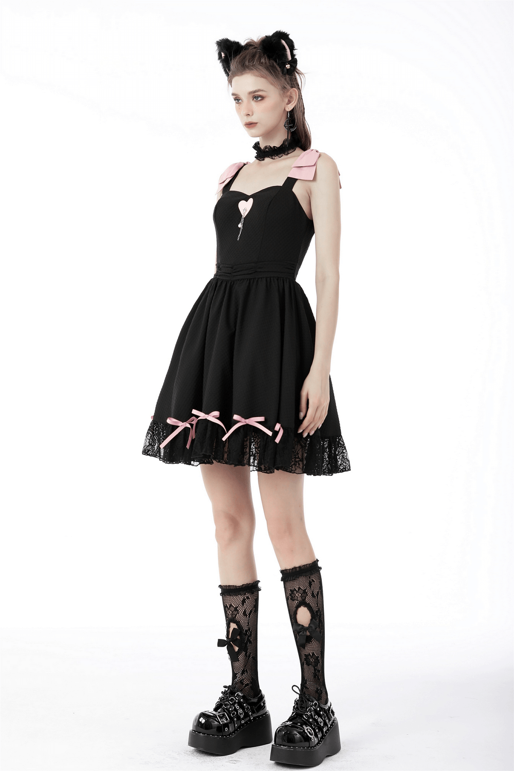 Elegant black dress with pink ribbons, lace details, and heart pendant; perfect for parties and special occasions.