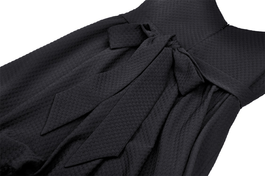 Close-up of the elegant black dress featuring pink ribbons and a chic bow detail, perfect for parties.