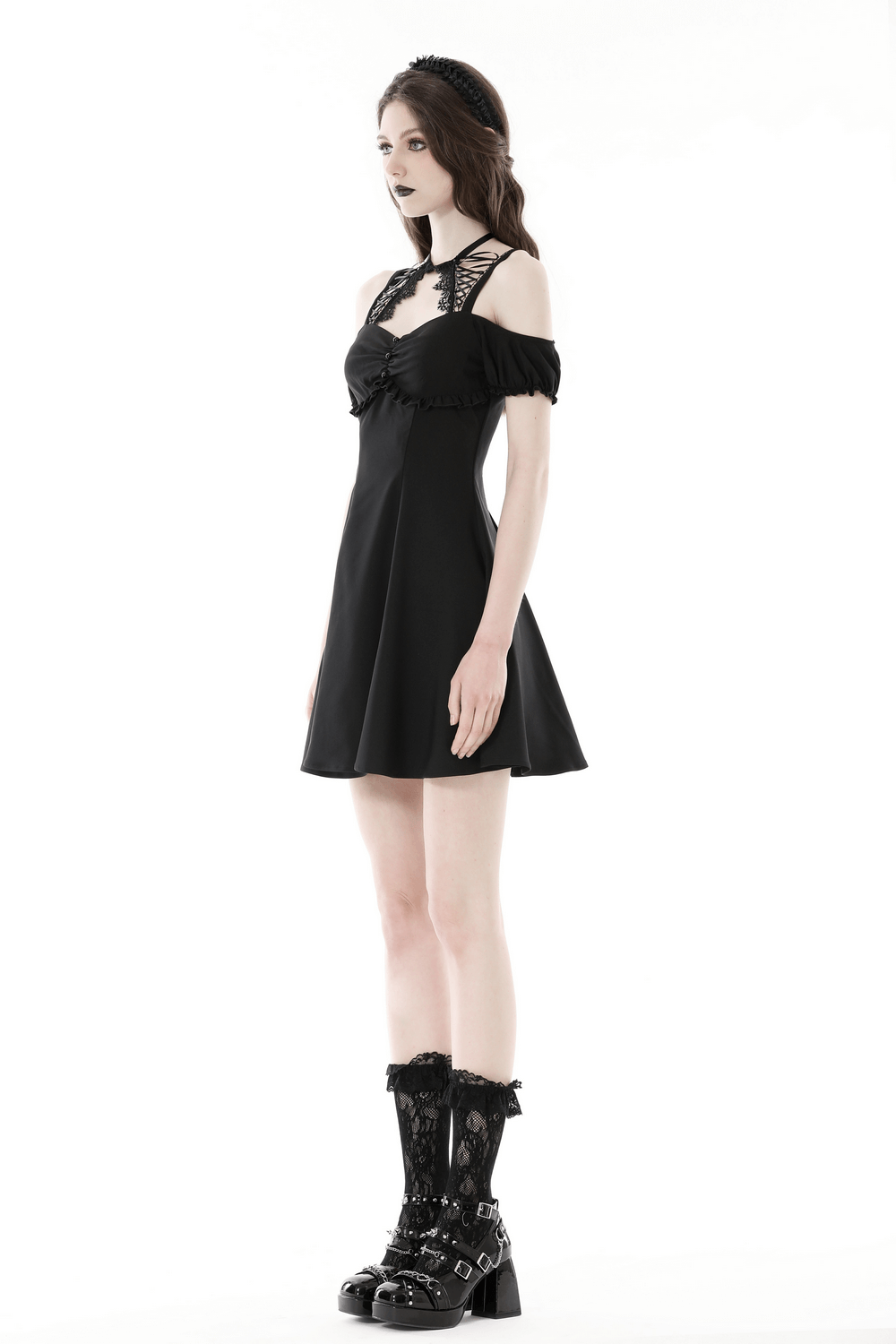 Elegant black mini dress with unique neckline and sleeve detail, perfect for a gothic-inspired look.
