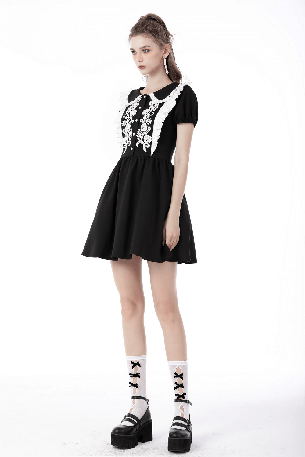 Chic black dress with elegant white floral embroidery and Peter Pan collar, perfect for stylish occasions.