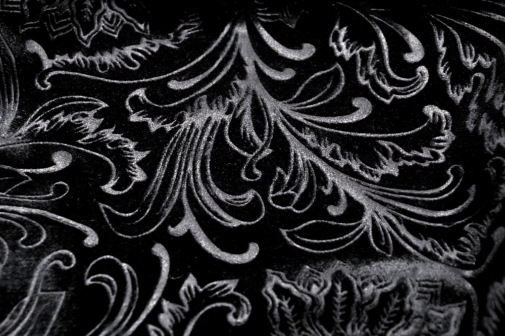 Elegant black lace pattern featuring intricate floral designs, perfect for stylish evening wear and accessories.