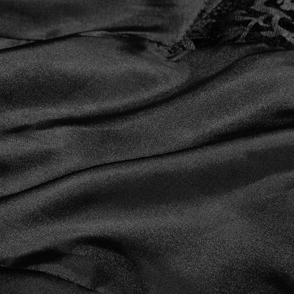 Close-up of luxurious black jacquard fabric with a smooth satin finish, ideal for elegant gothic fashion.