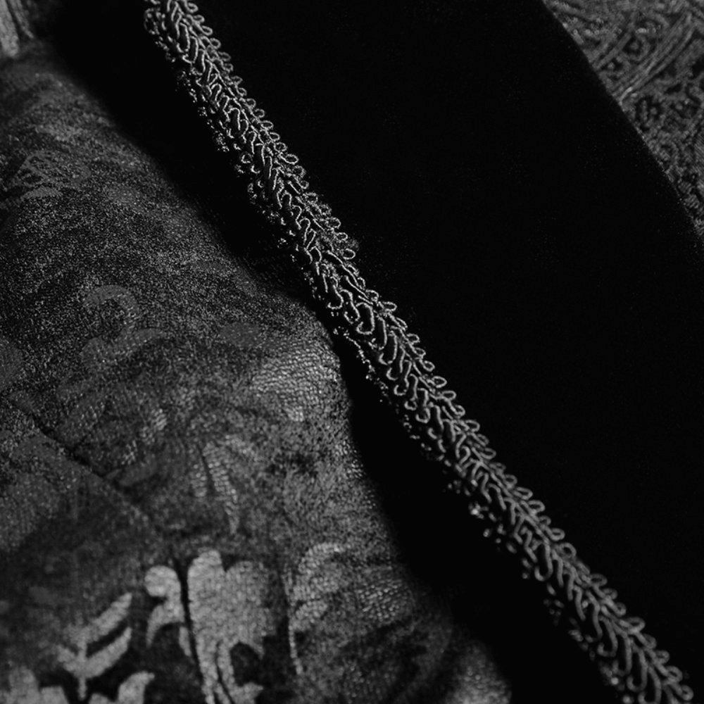 Close-up of elegant black floral jacquard fabric with velveteen detail, showcasing intricate embroidery design.