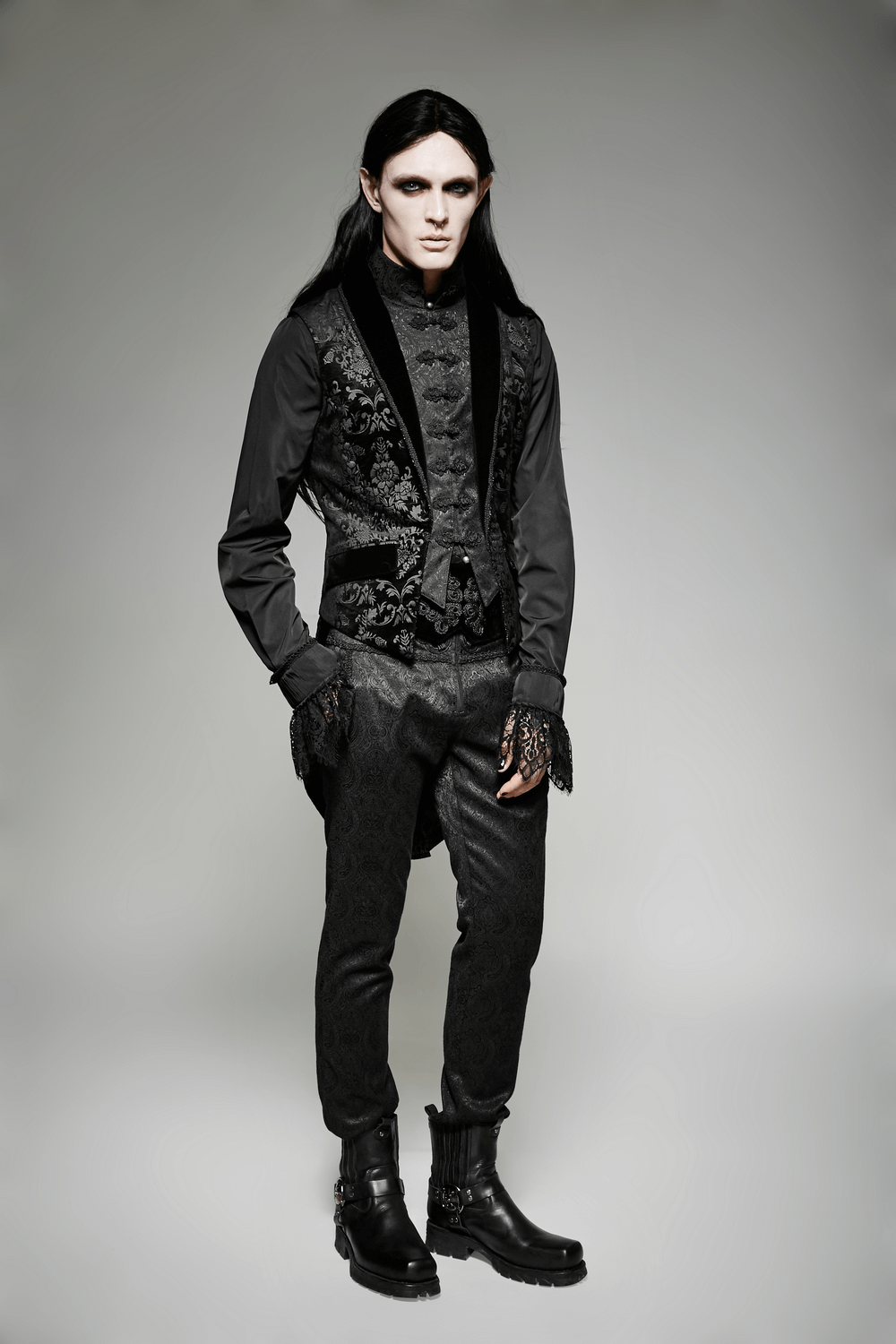 Gothic elegance: model showcasing an Elegant Black Floral Jacquard Swallowtail Vest with striking accessories.