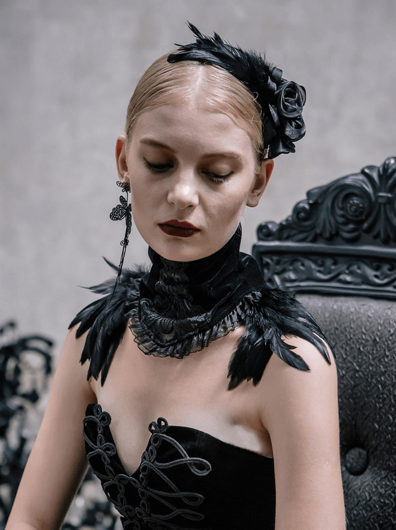 Elegant gothic woman wearing a black flower hair clip with feathers and stylish attire, exuding dark elegance.