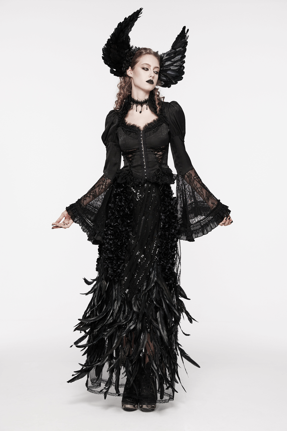 Elegant black Gothic skirt with feathers and rose petals, styled with a dramatic black top and statement accessories.