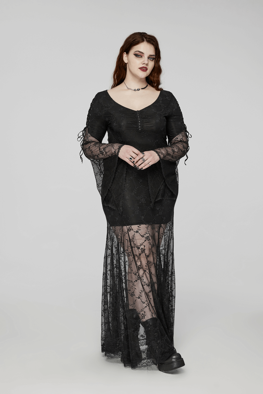 Elegant black gothic lace dress with knitted fabric, featuring a stunning lace overlay and dramatic sleeves.