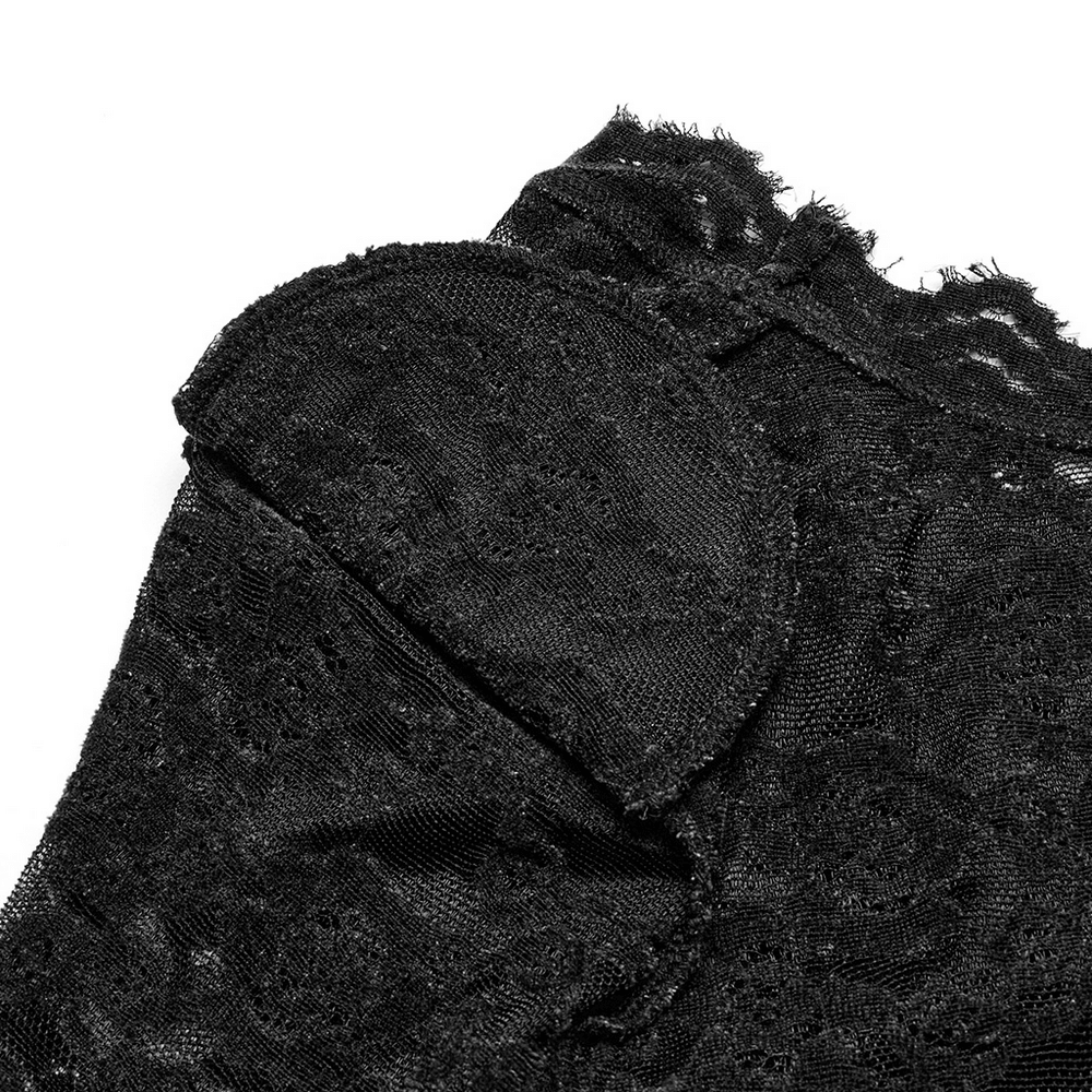 Close-up of elegant black lace detailing on gothic long sleeve V-neck top, showcasing intricate texture.