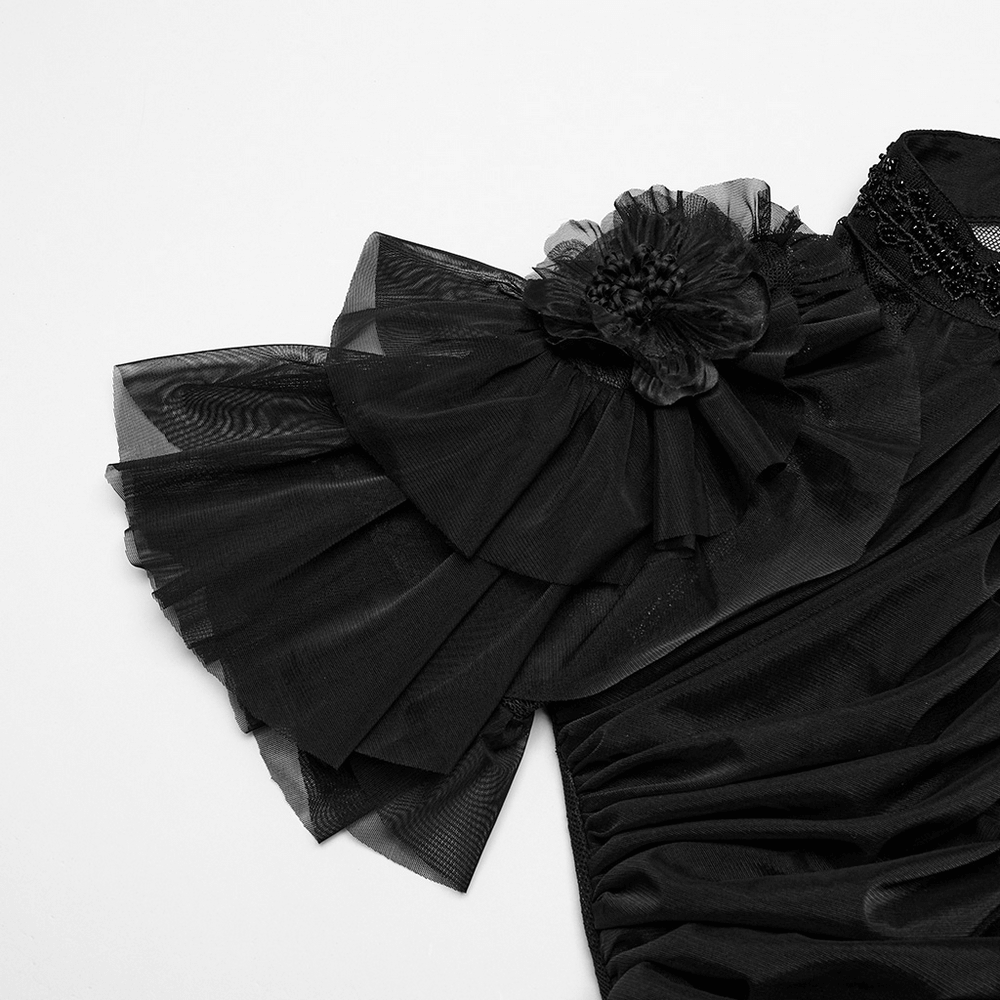 Elegant black lace dress shoulder with ruffled sleeve and handmade flower detail, showcasing gothic style.
