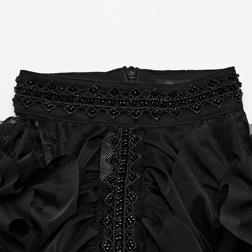 Close-up of the elegant black gothic lace maxi dress with beaded neckline and ruffles, showcasing detailed embroidery.