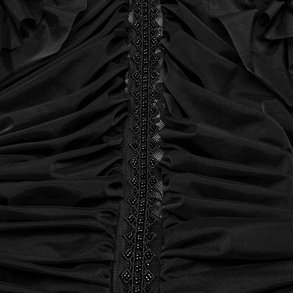 Elegant black lace fabric with ruffles and intricately beaded detail on a gothic maxi dress.