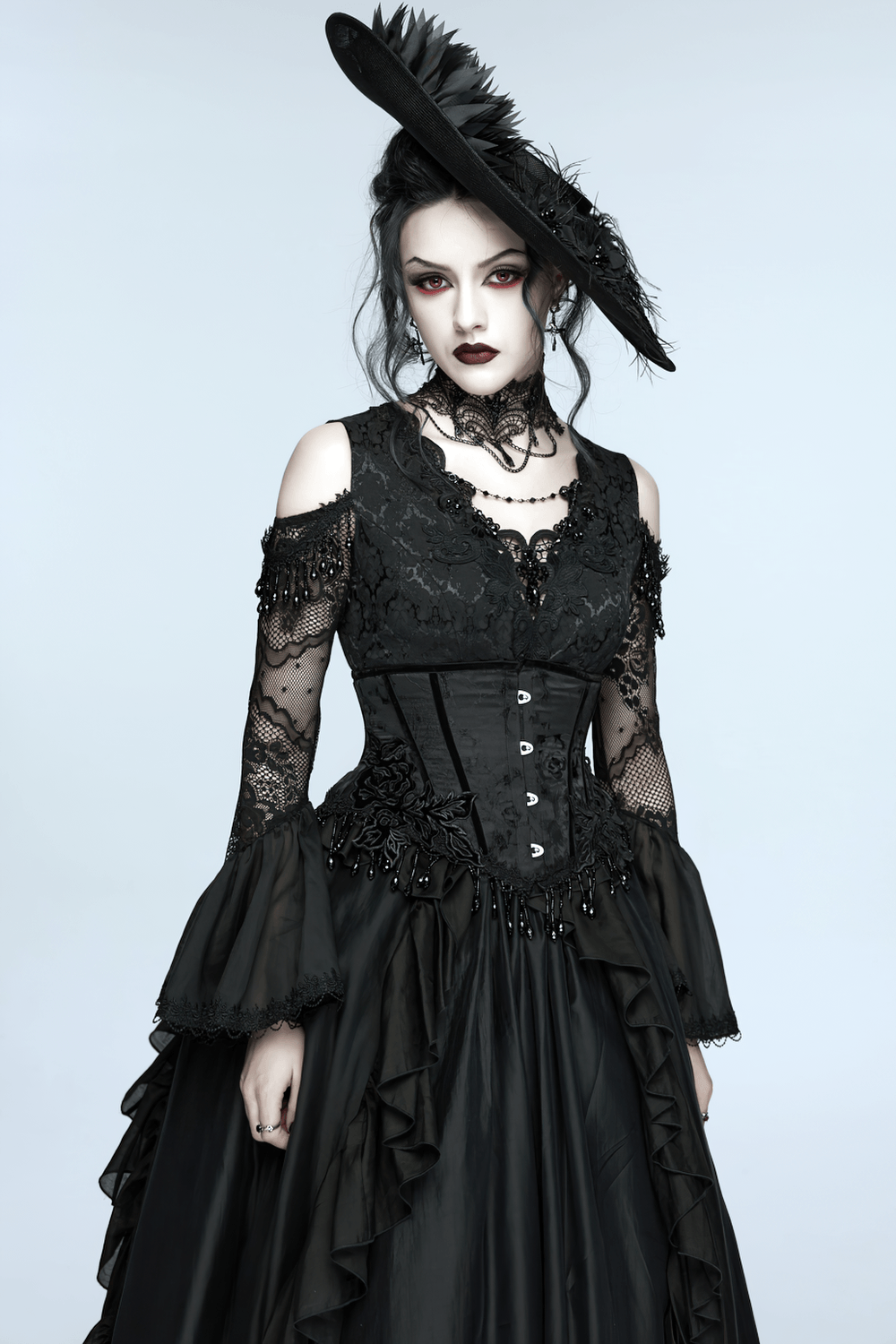 Elegant Black Gothic Rose Lace-Up Underbust Corset on model in black lace goth dress with rose appliqués and beaded fringe, dramatic gothic look