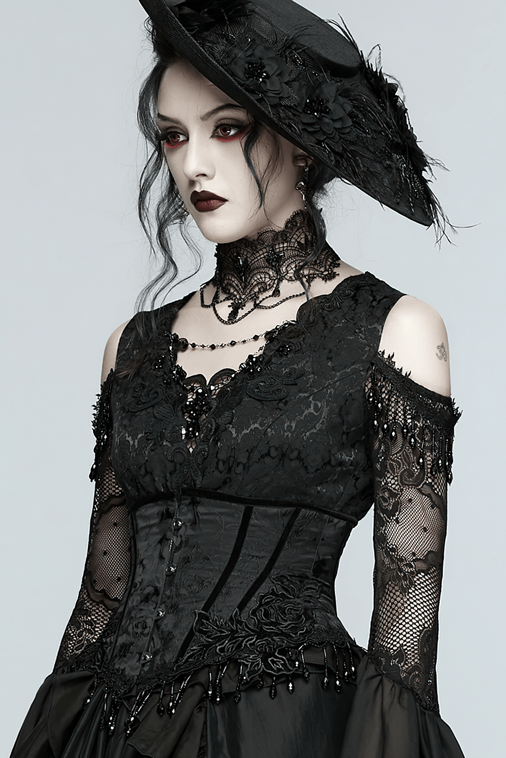 Elegant Black Gothic Rose Lace-Up Underbust Corset styled with black lace dress, beaded fringe vibe, and dramatic gothic hat