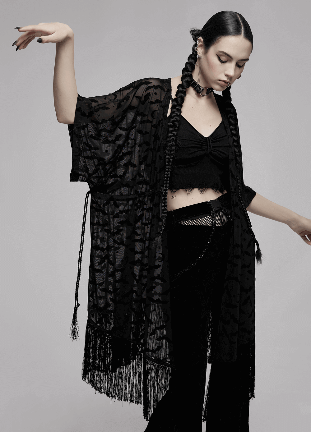 Elegant black lace bat print kimono-cape with tassels, styled with matching black outfit, creating a gothic vibe.