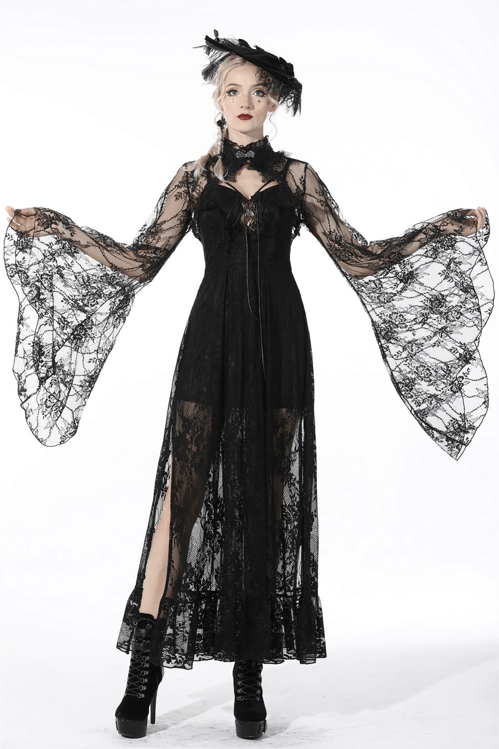 Model showcasing an elegant black lace cape with long bell sleeves in a dramatic gothic style.