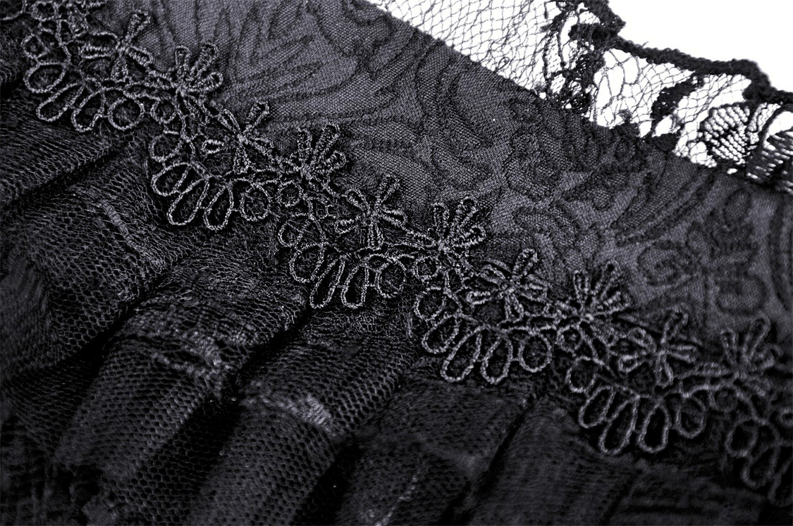 Close-up of elegant black lace detailing featuring intricate floral patterns and bell sleeve design.