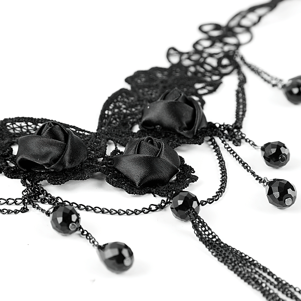 Elegant black lace choker with floral rose details and dangling beads, showcasing Gothic elegance.