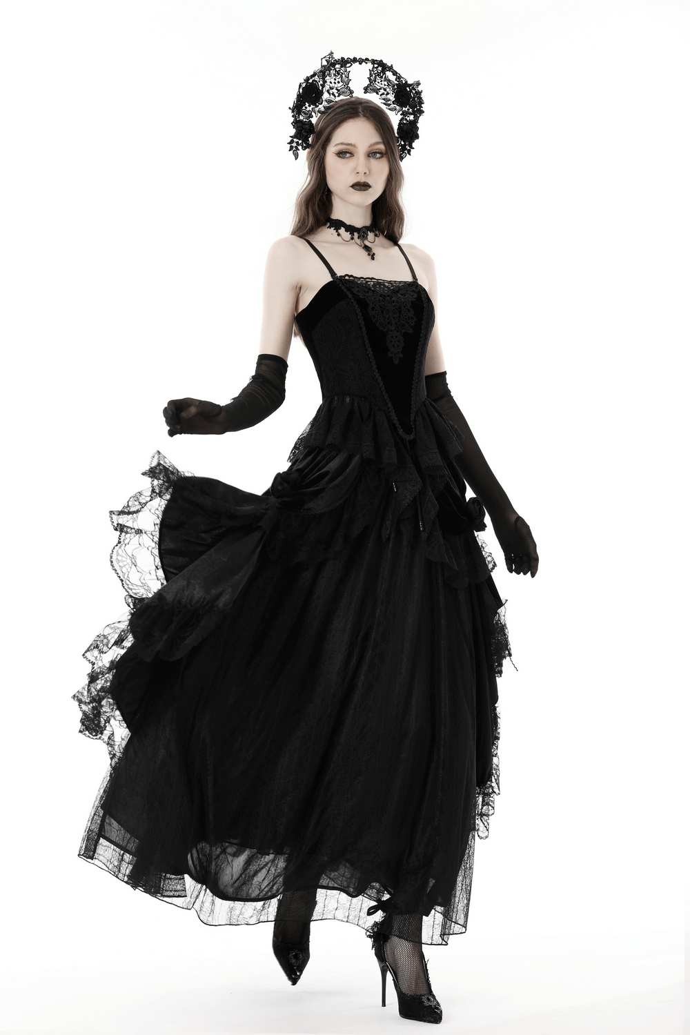 Elegant model in a gothic-inspired black lace corset dress, showcasing floral details and dramatic movement.