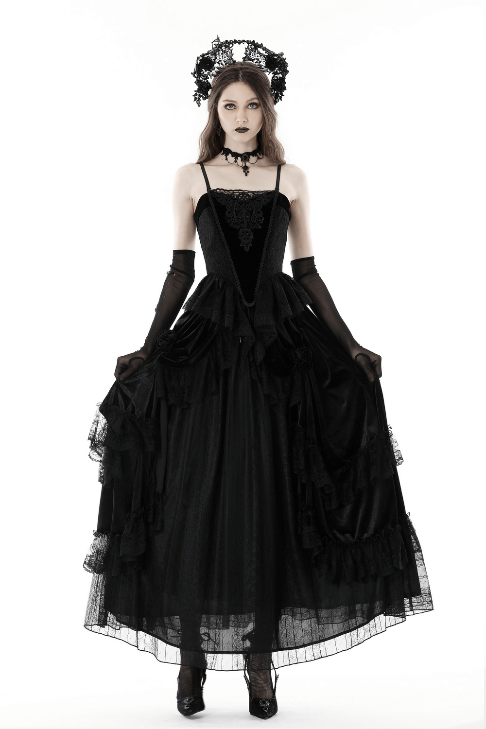 Elegant black lace corset top and long dress modeled by a woman with gothic accessories, perfect for evening wear.