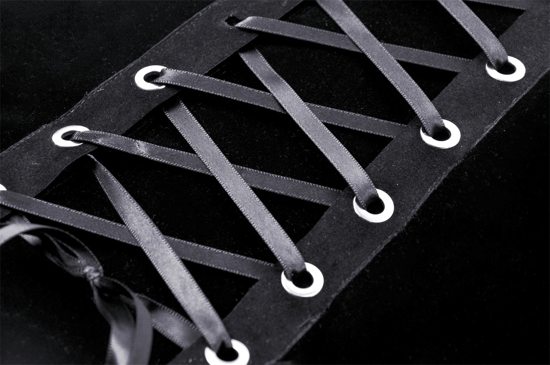 Close-up of a black lace corset top featuring elegant lace-up detailing and floral accents for evening wear.